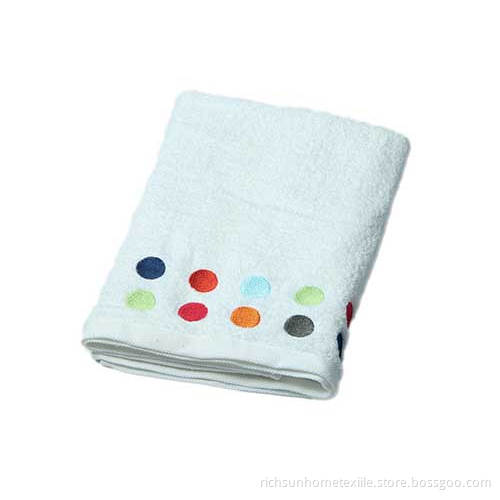 white embroidered bath towel